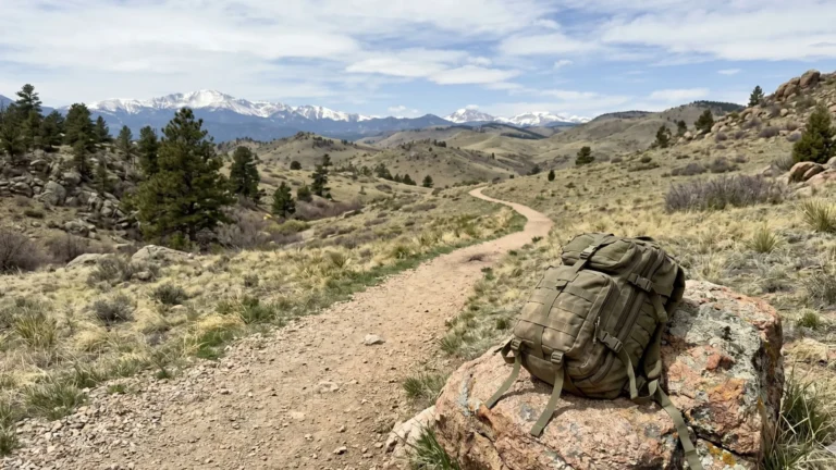 Rucksack placed beside mountain trail showing scenic rucking route and outdoor training environment.